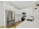 Modern kitchen featuring stainless steel appliances, white cabinetry, and quartz countertops at 2382 Carpenter Ln, North Port, FL 34286