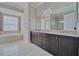 Bright bathroom featuring a soaking tub, double vanity with granite countertops, and tiled flooring at 5120 Tidewater Preserve Blvd, Bradenton, FL 34208