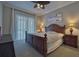 Comfortable bedroom with a king-size bed, soft carpet, and curtains, creating a relaxing retreat at 5120 Tidewater Preserve Blvd, Bradenton, FL 34208