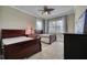 Comfortable bedroom featuring two beds, neutral walls and soft carpet, lit by a decorative ceiling fan with lights at 5120 Tidewater Preserve Blvd, Bradenton, FL 34208