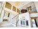 Spacious home foyer featuring high ceilings, an elegant staircase, and stylish decor at 5120 Tidewater Preserve Blvd, Bradenton, FL 34208