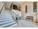 Elegant foyer with staircase, tiled floors, and decorative accents, showcasing a grand entrance at 5120 Tidewater Preserve Blvd, Bradenton, FL 34208