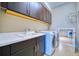 Functional laundry room with modern washer and dryer, ample counter space, and extra storage at 5120 Tidewater Preserve Blvd, Bradenton, FL 34208