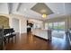 Open concept living room with a view to the kitchen, featuring hardwood floors and natural light at 5120 Tidewater Preserve Blvd, Bradenton, FL 34208