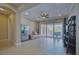 Open-concept living room with tiled floors, a sliding glass door to the patio, and modern furnishings at 5120 Tidewater Preserve Blvd, Bradenton, FL 34208