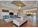 Spacious living room features a large sofa, rug, modern entertainment center, and open view to the foyer with a piano at 5120 Tidewater Preserve Blvd, Bradenton, FL 34208