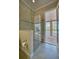 Close view of the shower with glass door showing the patio through an open door at 5120 Tidewater Preserve Blvd, Bradenton, FL 34208