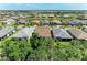 Aerial view of homes in a community surrounding a beautiful lake at 7572 Viola Loop, Lakewood Ranch, FL 34202