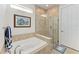 Bright bathroom with a soaking tub, glass shower, and neutral tile at 7572 Viola Loop, Lakewood Ranch, FL 34202