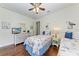 Bright bedroom features two twin beds, ceiling fan, dresser and seaside themed decor at 7572 Viola Loop, Lakewood Ranch, FL 34202