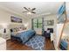 Bedroom with a large bed, ceiling fan, a flat-screen TV, and matching blue accents at 7572 Viola Loop, Lakewood Ranch, FL 34202