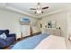 Inviting main bedroom with hardwood floors, a ceiling fan, and white wooden furniture at 7572 Viola Loop, Lakewood Ranch, FL 34202