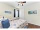 Cozy bedroom with twin beds, hardwood floors, and beach-themed decor at 7572 Viola Loop, Lakewood Ranch, FL 34202