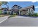 Clubhouse exterior with porte cochere, stone accents, and lush landscaping at 7572 Viola Loop, Lakewood Ranch, FL 34202