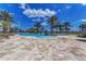 Stunning community pool area with palm trees, lounge chairs, and a splash fountain feature at 7572 Viola Loop, Lakewood Ranch, FL 34202