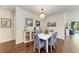 Coastal dining room with modern chandelier and views of the pool deck at 7572 Viola Loop, Lakewood Ranch, FL 34202