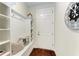 Mud room features built-in bench with storage cubbies and a nautical themed clock at 7572 Viola Loop, Lakewood Ranch, FL 34202