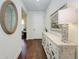 Bright foyer with hardwood floors, decorative mirror, stylish console table, and a welcoming ambiance at 7572 Viola Loop, Lakewood Ranch, FL 34202