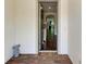 View through the doorway, showcasing the foyer with hardwood floors and a glimpse of the home's interior at 7572 Viola Loop, Lakewood Ranch, FL 34202