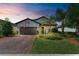 Charming home featuring a brick driveway, two car garage, and well manicured landscaping at 7572 Viola Loop, Lakewood Ranch, FL 34202