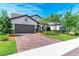 Charming home with a brick driveway, well-manicured lawn, and a two-car garage at 7572 Viola Loop, Lakewood Ranch, FL 34202