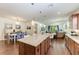 Spacious kitchen boasts an oversized island with pendant lights open to the dining area at 7572 Viola Loop, Lakewood Ranch, FL 34202