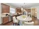 Gourmet kitchen featuring a large island with seating, stainless steel appliances, and granite countertops at 7572 Viola Loop, Lakewood Ranch, FL 34202