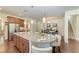 Open kitchen featuring a granite island with seating and pendant lighting at 7572 Viola Loop, Lakewood Ranch, FL 34202