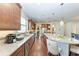 Modern kitchen with an island, stainless steel appliances, granite counters, and ample cabinet space at 7572 Viola Loop, Lakewood Ranch, FL 34202