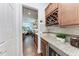 Kitchenette featuring a wine rack, granite countertops, and elegant cabinetry at 7572 Viola Loop, Lakewood Ranch, FL 34202