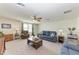 Relaxing living room featuring comfortable sofas, accent lighting, and large windows at 7572 Viola Loop, Lakewood Ranch, FL 34202