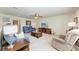 Spacious living room features comfortable seating, a ceiling fan, and a TV for relaxation at 7572 Viola Loop, Lakewood Ranch, FL 34202