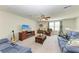 Bright upstairs living room features comfortable seating, entertainment center and large windows at 7572 Viola Loop, Lakewood Ranch, FL 34202