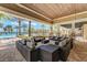 Inviting covered outdoor lounge area with comfortable seating and a serene pool view at 7572 Viola Loop, Lakewood Ranch, FL 34202