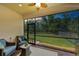 Enjoy the screened-in patio overlooking a spacious backyard surrounded by mature trees and a black metal fence at 7572 Viola Loop, Lakewood Ranch, FL 34202