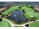 Aerial view of a lush golf course with a lake at 4515 Terrazza Ct, Lakewood Ranch, FL 34211