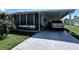 Front view of the home showcasing the carport and landscaping at 606 Cyprus Ct, Bradenton, FL 34207