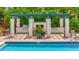 Community pool with adjacent grilling station and pergola at 5120 Tidewater Preserve Blvd, Bradenton, FL 34208