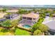 Aerial view of a house with a pool and screened lanai in a luxury community at 5120 Tidewater Preserve Blvd, Bradenton, FL 34208