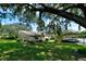 Exterior view of house with carport and landscaping at 3447 Tallywood Ln # 7143, Sarasota, FL 34237