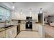 L-shaped kitchen with island, granite counters, and stainless steel appliances at 3447 Tallywood Ln # 7143, Sarasota, FL 34237