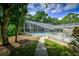 Community pool with lush landscaping and shaded seating at 3447 Tallywood Ln # 7143, Sarasota, FL 34237