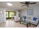 Living room with white couch, sliding doors to patio, and ceiling fan at 3447 Tallywood Ln # 7143, Sarasota, FL 34237