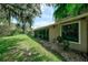 Spacious backyard with grassy area and mature trees at 3447 Tallywood Ln # 7143, Sarasota, FL 34237
