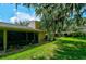 Private backyard with grassy area and screened patio at 3447 Tallywood Ln # 7143, Sarasota, FL 34237
