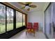 Relaxing screened-in porch with two red chairs and a small wooden table at 3447 Tallywood Ln # 7143, Sarasota, FL 34237