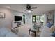 Relaxing living room with white sofas, glass coffee table, and access to patio at 3447 Tallywood Ln # 7143, Sarasota, FL 34237