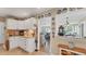 Charming kitchen with white cabinets, granite countertops and a view into the living room at 401 28Th W St, Bradenton, FL 34205