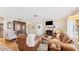 Bright and airy living room with hardwood floors, leather furniture, and a cozy fireplace at 401 28Th W St, Bradenton, FL 34205