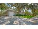 Gray house with a large oak tree and spacious driveway at 401 28Th W St, Bradenton, FL 34205